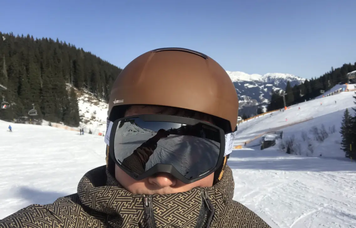 man with helmet and ski glasses in the snow